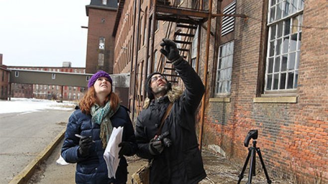 Historic preservation students examine unique characteristics of a former mill in Pawtucket.