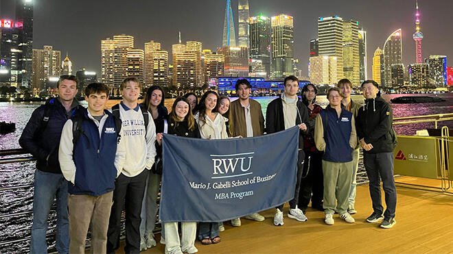 RWU MBA students hold BSB banner in China.