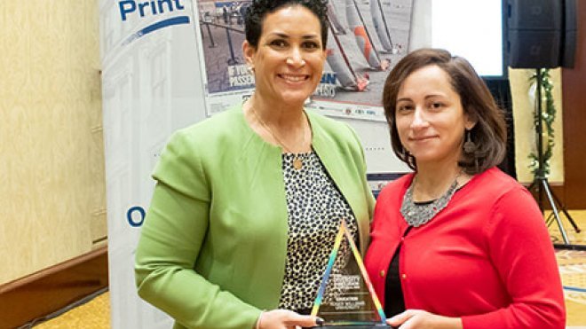 Lorraine Lalli and Zoila Quezada accept the award.