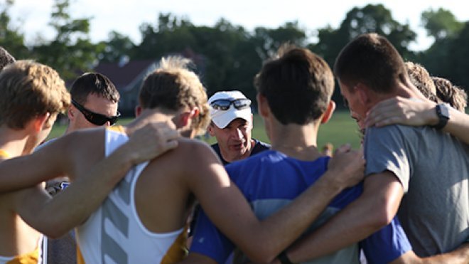 image of Sean Livingston, Head Coach - Cross Country and Track & Field, talking strategy with his team