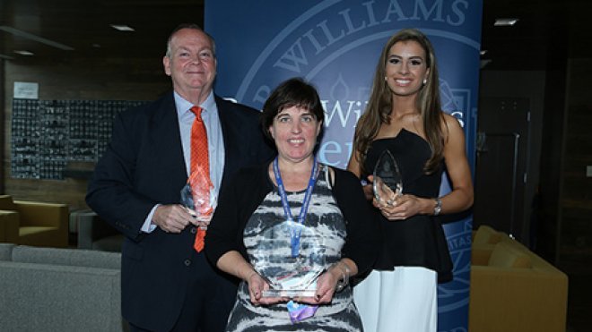 Three alumni hold their awards.