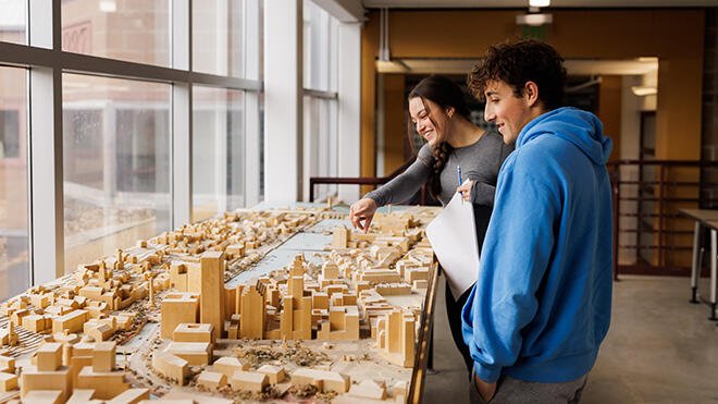 Architecture students look at their work