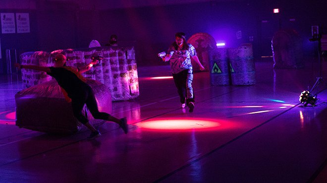 Students play blacklight laser tag