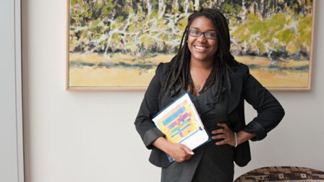 Student stands inside a classroom