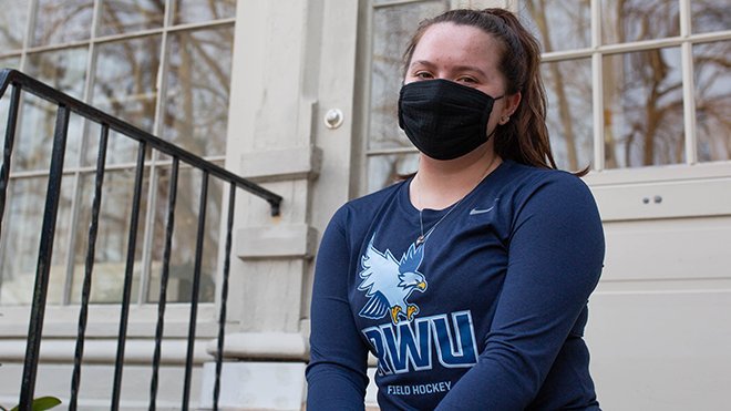 image of RWU Field Hockey's Community Outreach group’s Brooklyn Cenatiempo, who delivered donations to the Women’s Resource Center in Warren, RI, during Women’s History Month. 