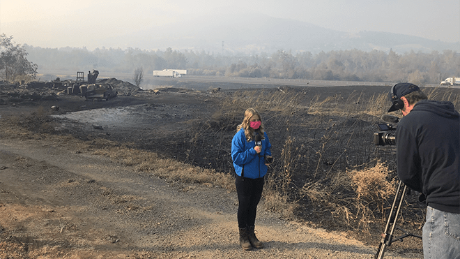 Journalism alumna reporting from the scene of an active fire in Oregon's wildfires.