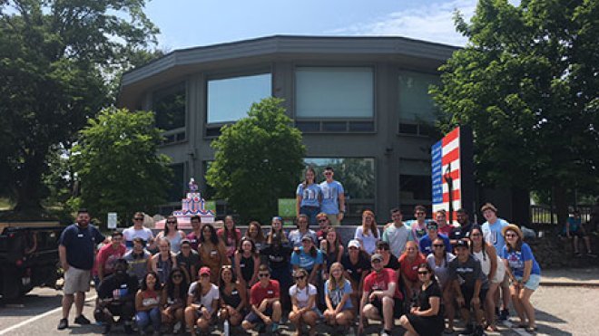 Students pose in front of the float.