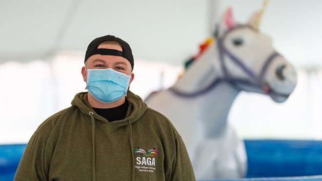 Grayson Scanlon in front of a unicorn 