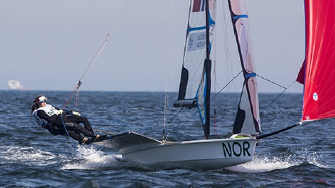 Olympic sailing athlete navigates her boat.