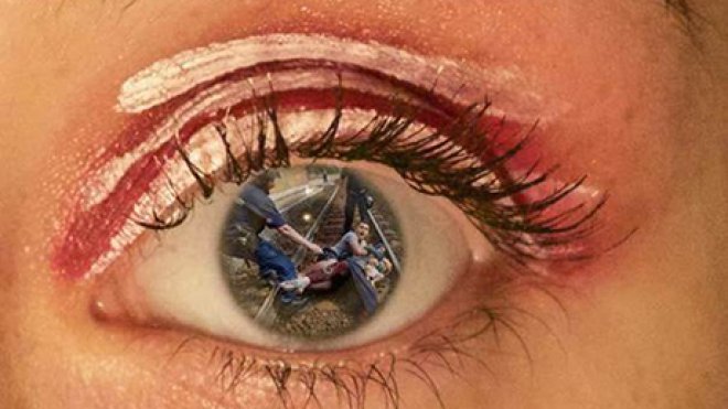 A collage of refugees within the pupil of an eye.