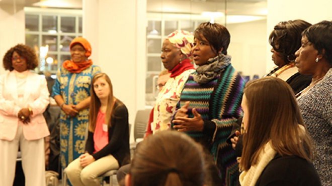 Women from a local refugee group talk to students about their experiences.