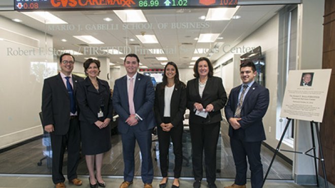 Students, faculty and donors celebrate the opening of a renovated financial trading room.