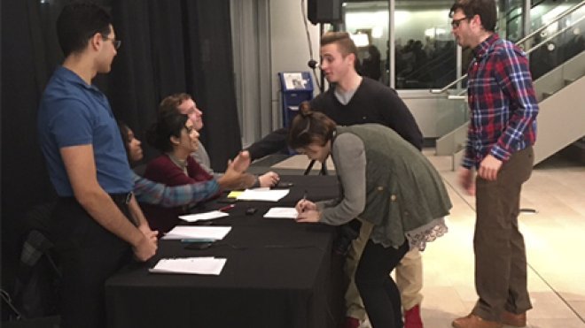 Students gather to talk and sign an agreement to continue civil discourse.