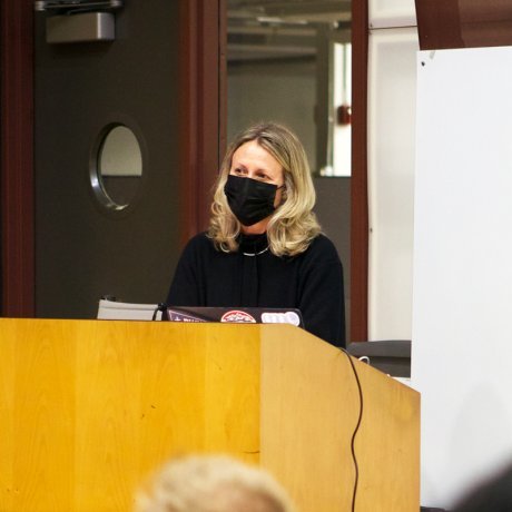 A woman presenting with a mask on. 
