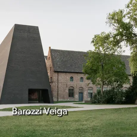 A front yard view of a building by Barozzi Veiga