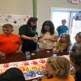 Campers and director work on a project.