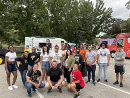 A group of students in front of a food truck