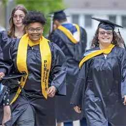 Graduates walk at commencement