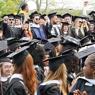 An image of RWU graduates celebrating in a crowd at commencement
