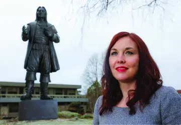 Charlotte Carrington-Farmer standing next to statue of Roger Williams