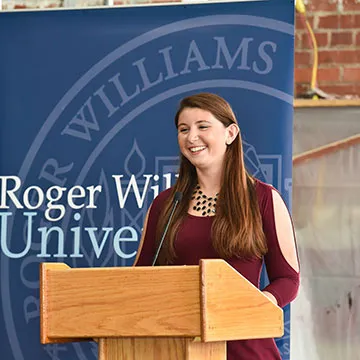 A headshot of Angelina Ferrari giving a speech.