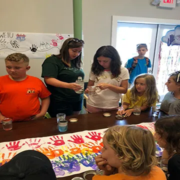 Campers and director work on a project.