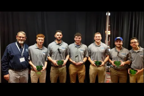 Construction Management student team and professor.