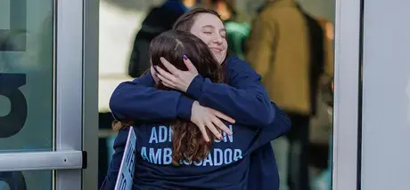 Student hugs admission ambassador
