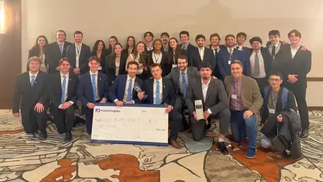 Construction Management students accept a $2,000 prize alongside their faculty advisors.