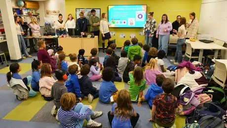 Roger Williams University preservice teachers lead second graders from The Croft School through a hands-on coding lesson.