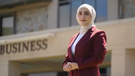 Abida Mohammady stands outside of the Mario J. Gabelli School of Business.
