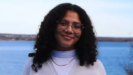 Alicia Ortiz Alba smiling in front of Mt. Hope Bay