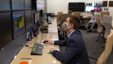 Student working on computer workstation in CAFE.