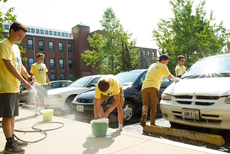 Students wash cars for residents of an independent living facility.
