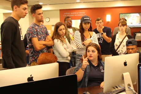 Emily Parratt shows first-year students the RWU Library