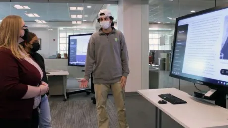 A student in Heather Miceli's CORE 101: Scientific Investigations course gives a presentation on his group's website about evolution.