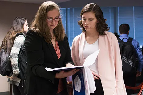 Two students looking over a document.