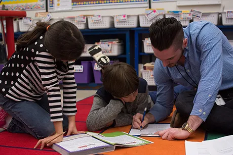 RWU student working with two students