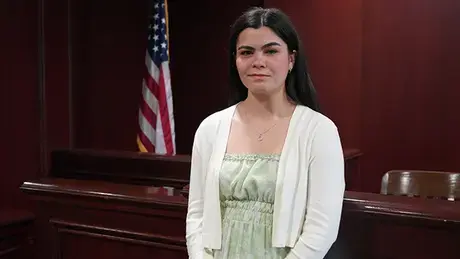 Olivia DaSilva standing in a trial room in RWU's Law School.