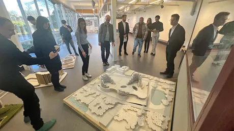 Perkins&amp;Will studio presenting their scale model to critics