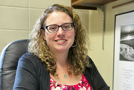 A photo of Professor Russano at her desk.