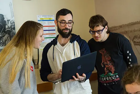Students looking at a laptop