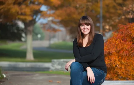 Student sits in the university quad.