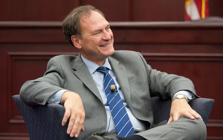 Chief Justice sits in a classroom