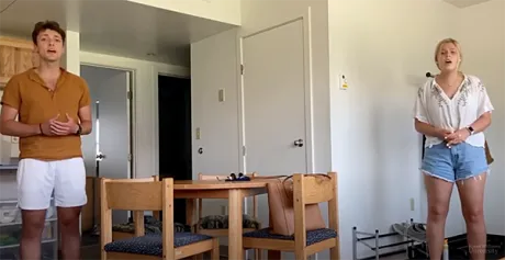 image of a socially distanced Jordan Peck and Emily singing the national anthem at the start of this year's Convocation ceremony