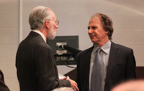 Two men greet each other