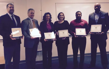 Graduates pose with certificates