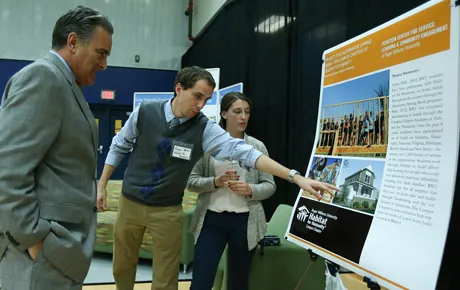 Student demonstrates info on his poster