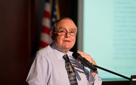 Man speaks at podium