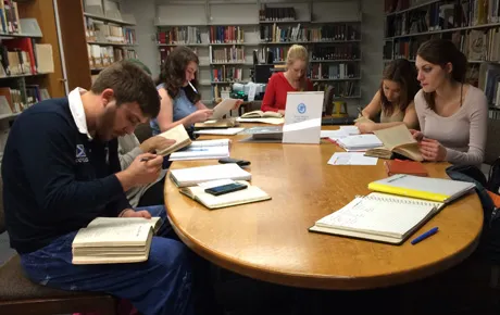 Students research in library archives